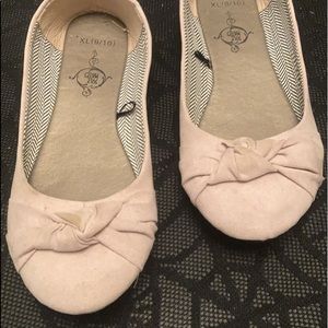 Sole Mates Crème colored flats.